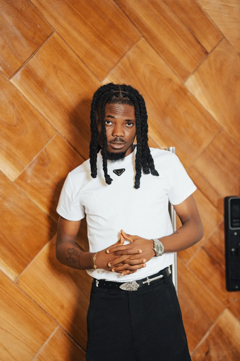 Emmy Blaq in a white T-shirt with hands together, ready